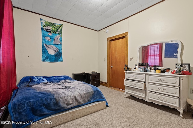 bedroom with carpet floors and crown molding