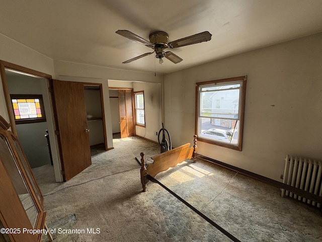 210 School St, Scranton, PA 18508 - unfurnished bedroom with radiator heating unit, two closets, ceiling fan, and baseboards