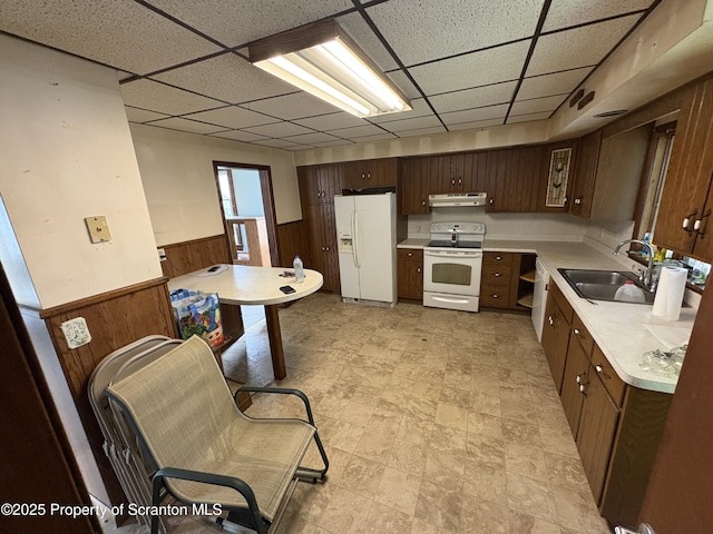 210 School St, Scranton, PA 18508 - kitchen with white appliances, a sink, a paneled ceiling, under cabinet range hood, and wainscoting