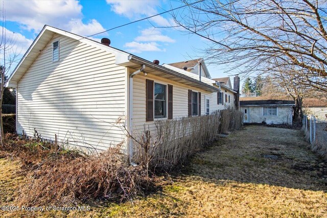view of side of home with fence