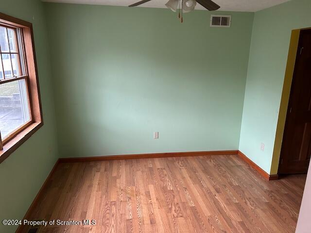 empty room featuring light hardwood / wood-style flooring and ceiling fan