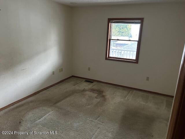 unfurnished room with carpet flooring