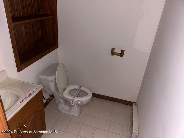 bathroom featuring vanity, a baseboard radiator, and toilet