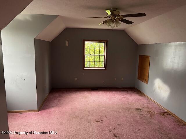 bonus room with ceiling fan, lofted ceiling, and light carpet