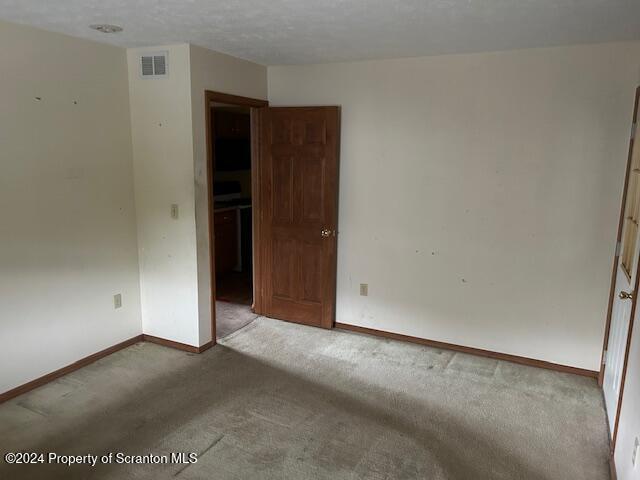 unfurnished room featuring carpet flooring