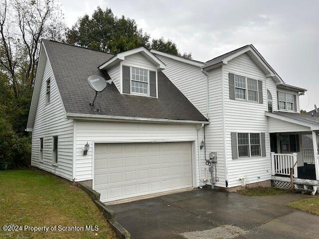 view of front of home featuring a garage and a front lawn