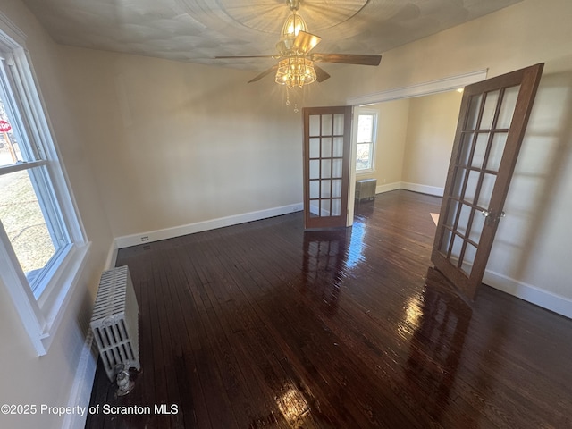 spare room with french doors, baseboards, a ceiling fan, and hardwood / wood-style flooring