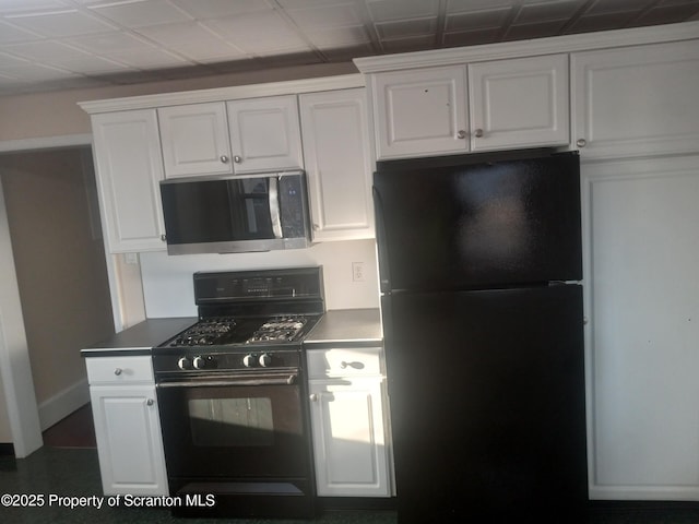 kitchen featuring white cabinetry and black appliances