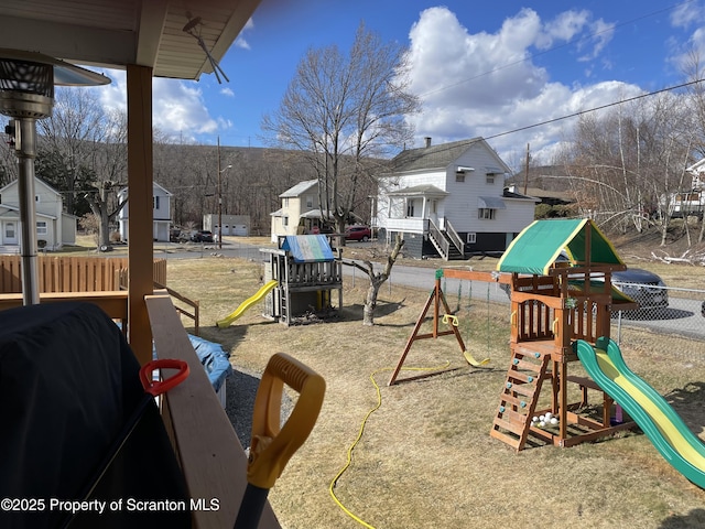 view of jungle gym featuring fence