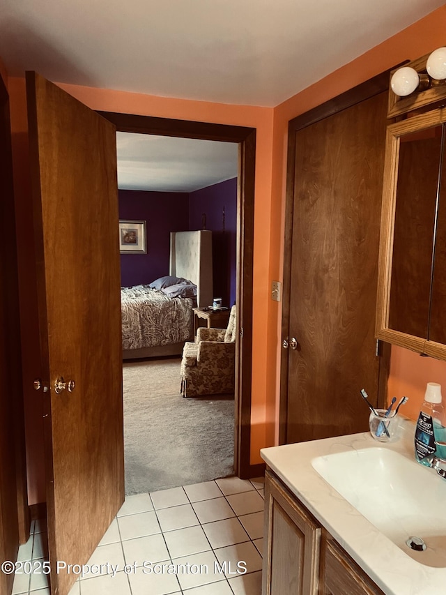 bathroom featuring tile patterned floors, vanity, and ensuite bath