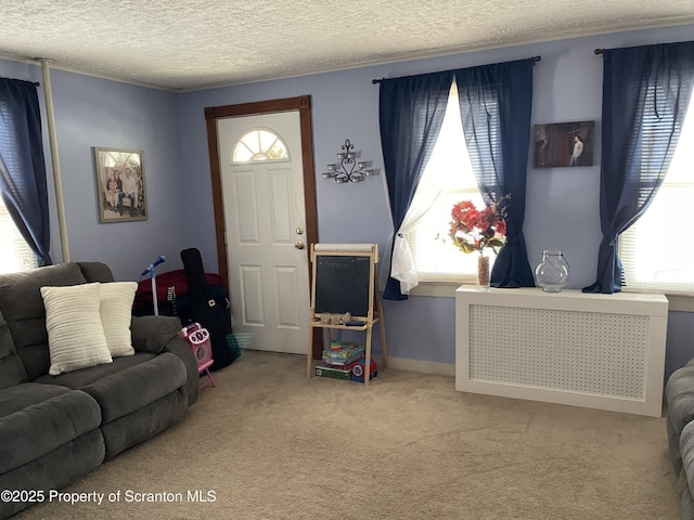 carpeted living room featuring plenty of natural light, radiator heating unit, baseboards, and a textured ceiling