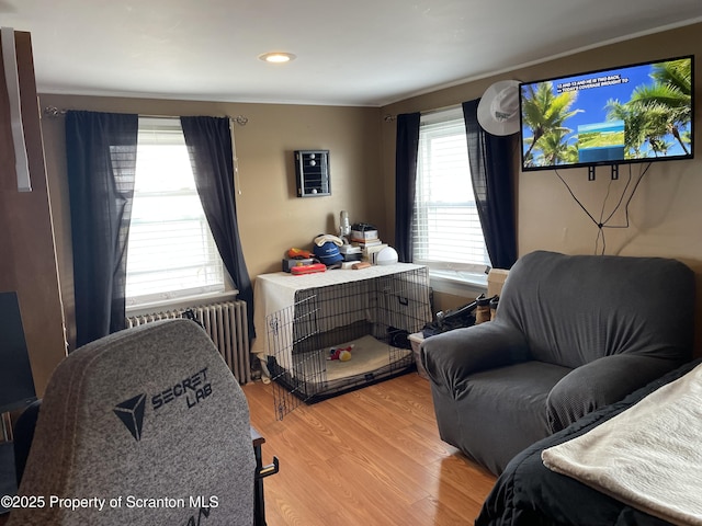 bedroom with recessed lighting, radiator heating unit, and wood finished floors