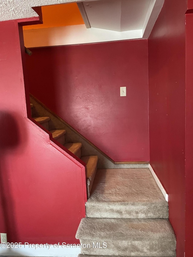 staircase with carpet flooring and baseboards