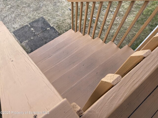 staircase with wood finished floors