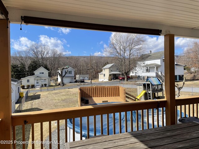 deck with a residential view and a playground