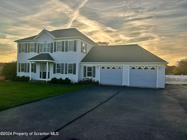 view of front of home featuring a lawn and a garage