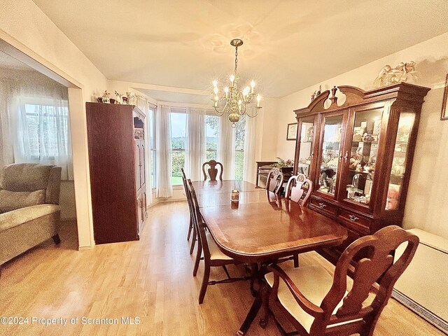 dining room featuring a chandelier and light wood-type flooring