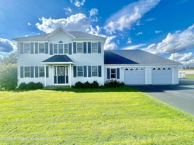 view of front of house featuring a garage and a front lawn