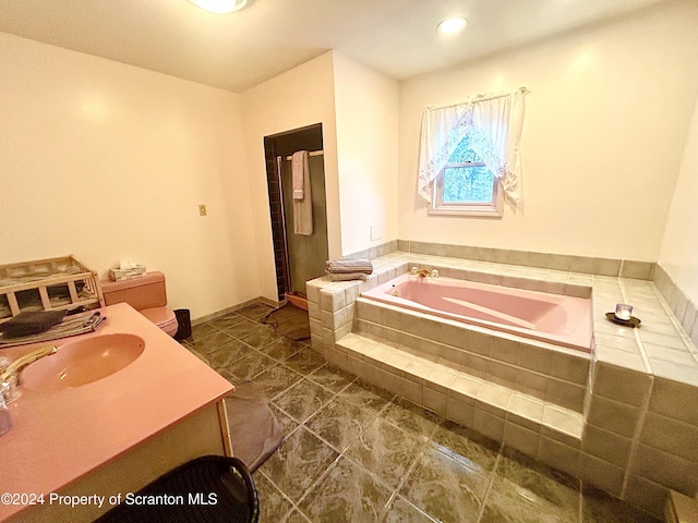 bathroom with vanity and independent shower and bath