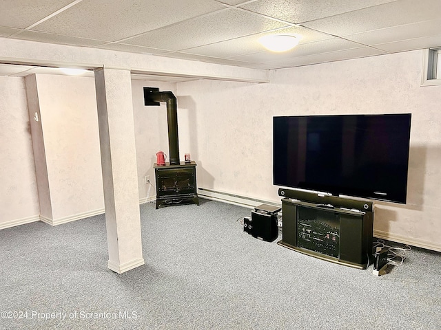 basement with carpet floors, baseboard heating, and a drop ceiling