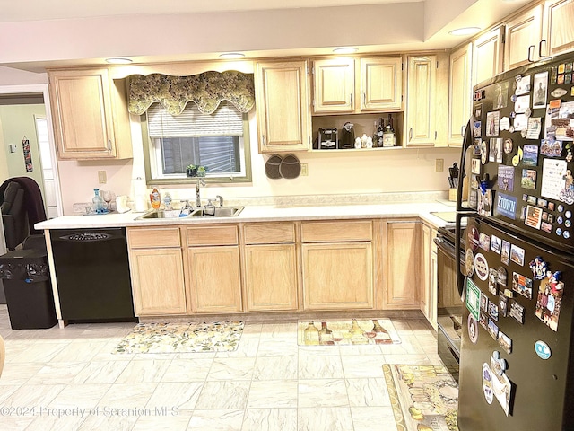 kitchen featuring black appliances, sink, and light brown cabinetry