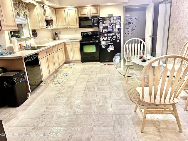 kitchen featuring black appliances, light brown cabinets, and sink