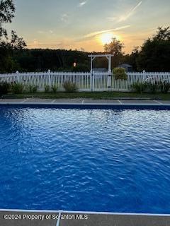 view of pool at dusk