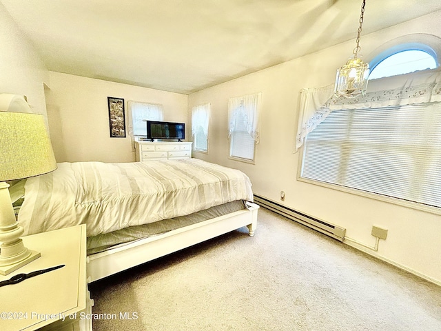 bedroom featuring baseboard heating and carpet