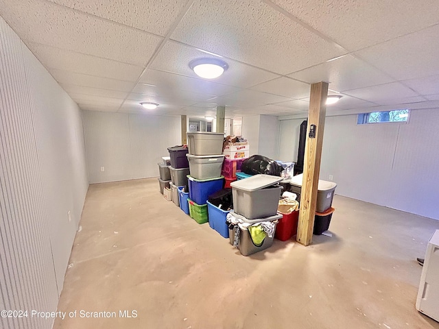 basement with a paneled ceiling