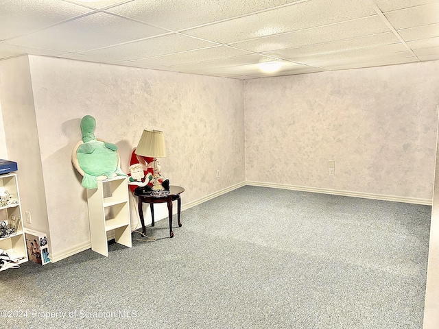 basement featuring carpet flooring and a paneled ceiling