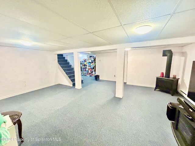 basement with carpet flooring and a drop ceiling