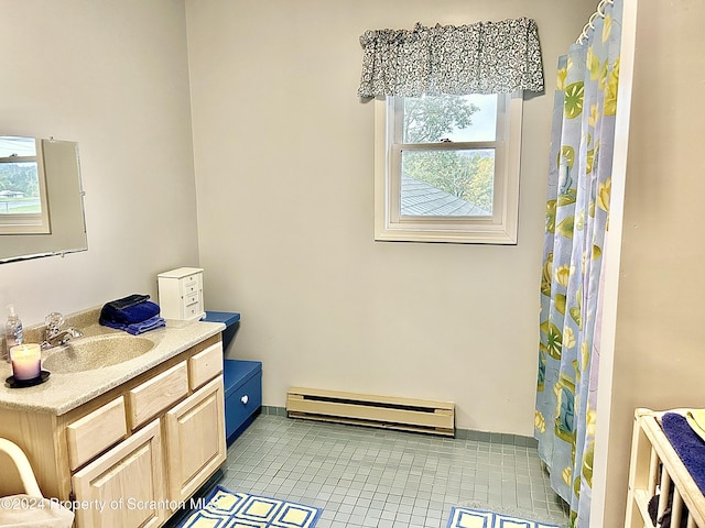 bathroom featuring baseboard heating, tile patterned flooring, vanity, and plenty of natural light