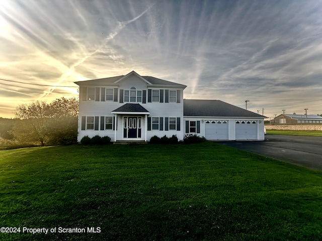 view of front of property with a lawn and a garage