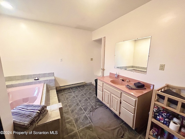 bathroom with a bathing tub, vanity, and a baseboard heating unit