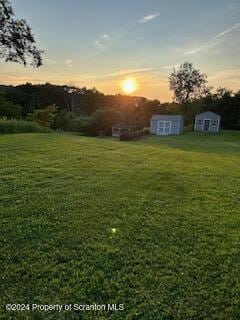 yard at dusk with a storage unit