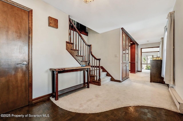 entryway with parquet flooring and a baseboard radiator