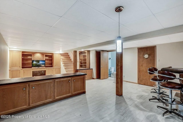 interior space with decorative light fixtures and a drop ceiling