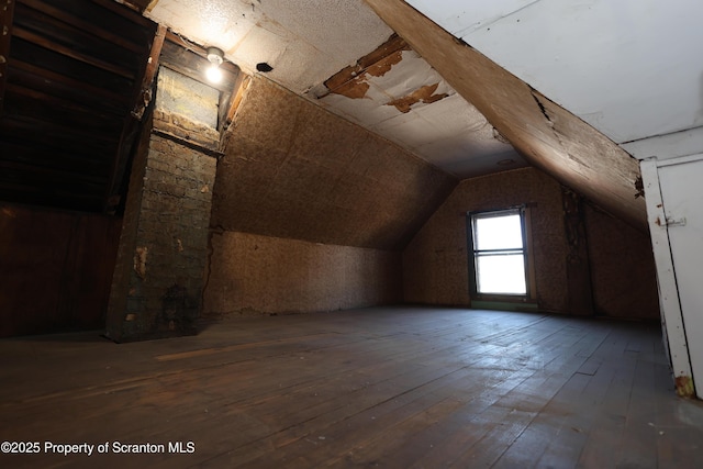 bonus room featuring wood-type flooring and vaulted ceiling