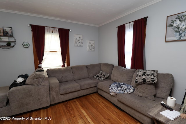 living area with crown molding and wood finished floors