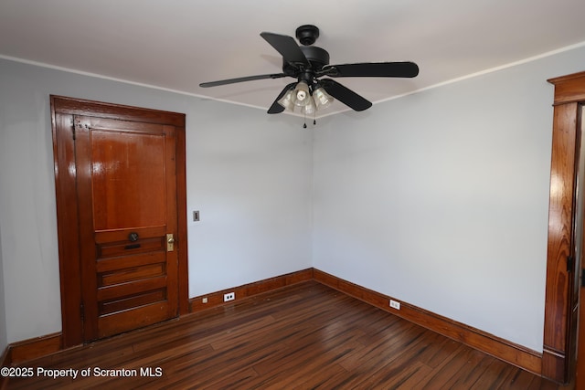 spare room with dark wood finished floors, ceiling fan, and baseboards