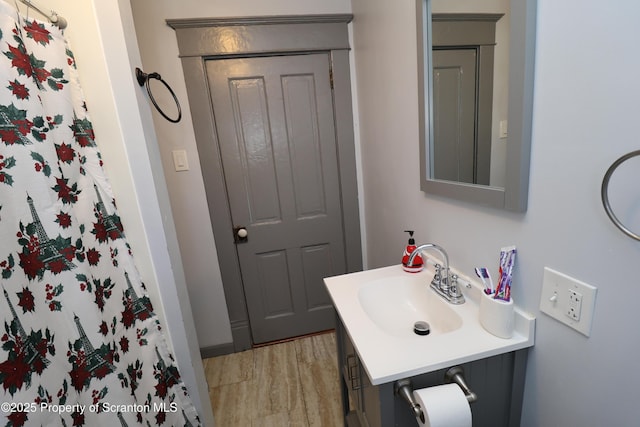 full bathroom with vanity and wood finished floors