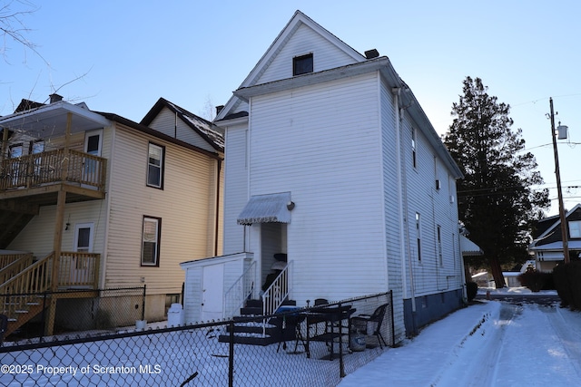 back of house featuring fence