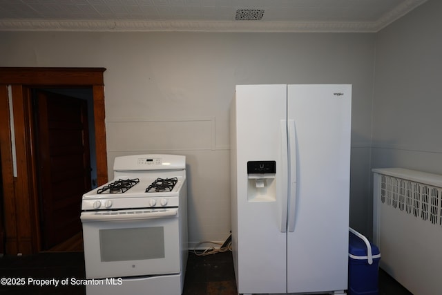 kitchen featuring white appliances, radiator, and visible vents