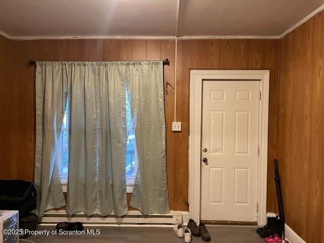 interior space with wood walls and ornamental molding