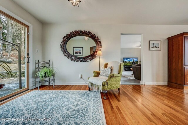 sitting room featuring baseboards and wood finished floors