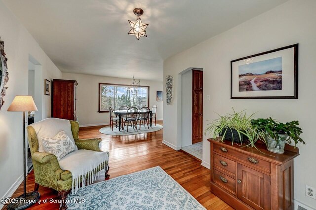 sitting room featuring baseboards and wood finished floors