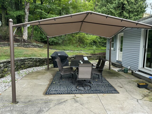 view of patio featuring entry steps, area for grilling, and outdoor dining space