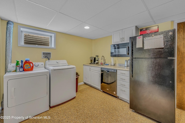 washroom with laundry area, washer and clothes dryer, and a sink