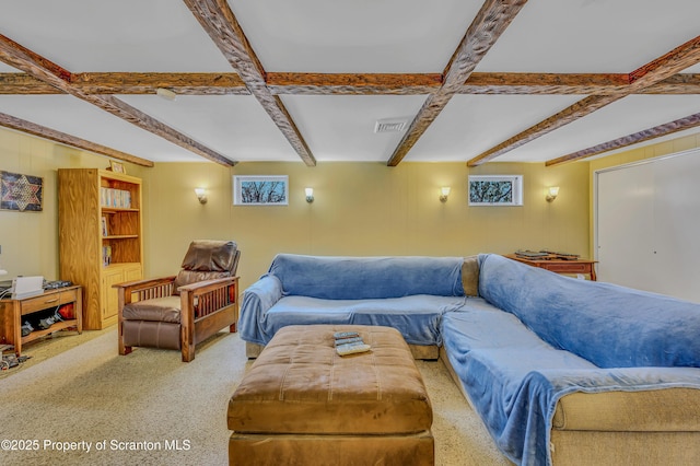 living area featuring visible vents and beam ceiling