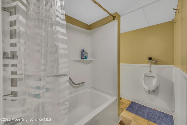 full bath featuring tile patterned floors and shower / bath combo with shower curtain